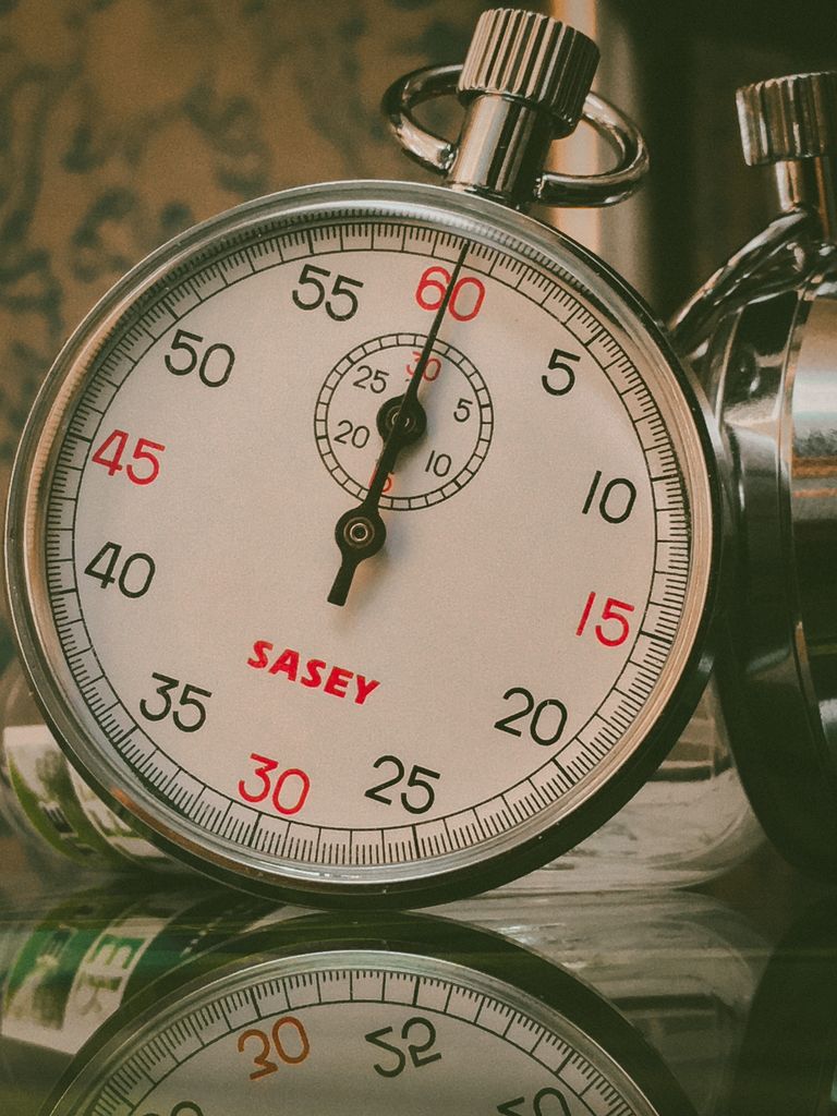 A detailed shot of a vintage analog stopwatch showing reflection. Perfect for time-related themes.